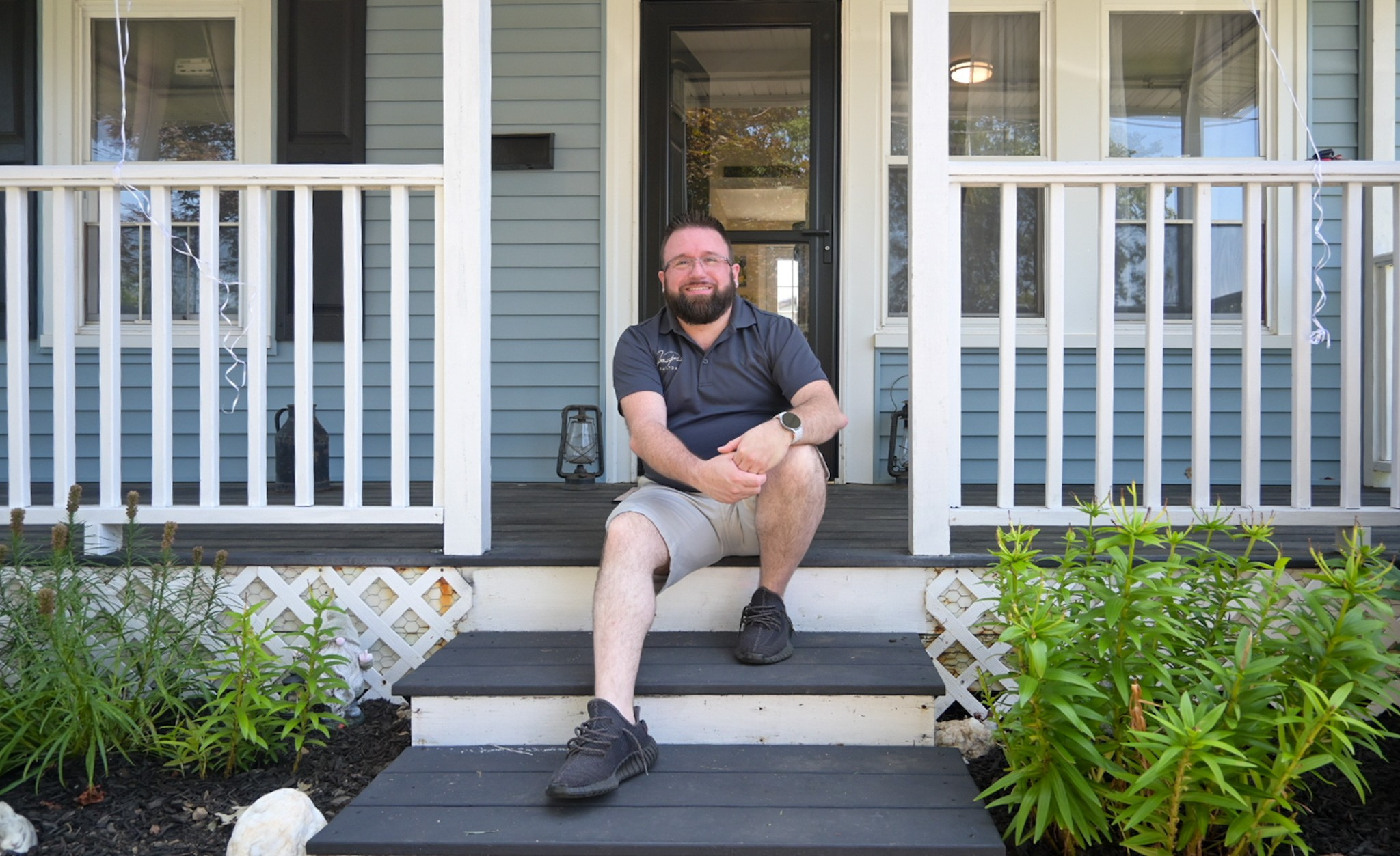 Joe Pine sitting on the front steps of a home